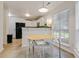 Eat-in kitchen with white cabinetry, stainless appliances, large bright windows, and adjoining breakfast area at 709 Black Oak Blvd, Summerville, SC 29485