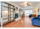 Bright living room featuring a fireplace, hardwood floors, shelving units, and ample natural light at 709 Black Oak Blvd, Summerville, SC 29485