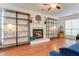 Bright living room featuring a fireplace, hardwood floors, shelving units, and ample natural light at 709 Black Oak Blvd, Summerville, SC 29485