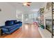 Open concept living room with hardwood floors, a fireplace, and a comfortable blue couch at 709 Black Oak Blvd, Summerville, SC 29485