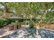 Expansive patio area with a dining set, perfect for outdoor entertaining under mature trees at 735 Woodward Rd, Charleston, SC 29407