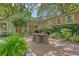 Exterior view of a backyard with an outdoor dining area, deck, and playhouse at 735 Woodward Rd, Charleston, SC 29407