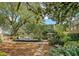 Expansive backyard with outdoor seating area and lush tropical landscaping at 735 Woodward Rd, Charleston, SC 29407