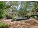 Green home features a lush backyard, outdoor seating area and tropical landscaping at 735 Woodward Rd, Charleston, SC 29407