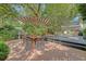 Charming backyard featuring an outdoor dining table, patio, and lush green landscaping at 735 Woodward Rd, Charleston, SC 29407