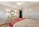 Bright bedroom featuring light colored dresser, decorative mirror and access to another area via black door at 735 Woodward Rd, Charleston, SC 29407