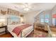 Comfortable bedroom features neutral walls, an iron bed frame, and a quaint desk area with a window at 735 Woodward Rd, Charleston, SC 29407