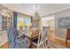 Bright dining room with hard wood table, upholstered chairs and custom built-ins at 735 Woodward Rd, Charleston, SC 29407