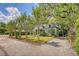 Charming home with green exterior, lush landscaping, and pea gravel driveway at 735 Woodward Rd, Charleston, SC 29407