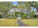 Alluring home showcasing a meticulously landscaped front yard, brick pathway and lush green foliage at 735 Woodward Rd, Charleston, SC 29407