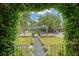 View from porch with manicured front yard, tree-lined street, and neatly kept landscaping at 735 Woodward Rd, Charleston, SC 29407