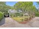 Charming home with a well-maintained lawn, mature trees, and a covered parking area with boat at 735 Woodward Rd, Charleston, SC 29407