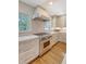 This kitchen features stainless steel appliances, wood floors and bright white subway tile back splash at 735 Woodward Rd, Charleston, SC 29407