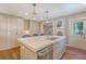 Kitchen island with marble countertop, sink, dishwasher, and seating for casual dining at 735 Woodward Rd, Charleston, SC 29407