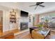 Charming living room with a fireplace, built-in shelves, and comfortable seating exudes warmth and character at 735 Woodward Rd, Charleston, SC 29407