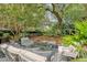 Outdoor living space with lounge furniture, greenery and lush landscaping at 735 Woodward Rd, Charleston, SC 29407