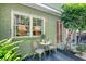 Quaint outdoor patio area for dining features bistro seating and lush plants at 735 Woodward Rd, Charleston, SC 29407