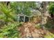 Nestled among lush foliage is a backyard shed with a garden path at 735 Woodward Rd, Charleston, SC 29407
