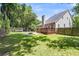 Large fenced backyard with a deck, patio, fire pit, and ample green space at 8166 Scottswood Dr, North Charleston, SC 29418