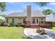Spacious backyard featuring a deck, patio with fire pit, and privacy fence at 8166 Scottswood Dr, North Charleston, SC 29418
