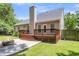 Large fenced backyard with a deck, patio, fire pit, and ample green space at 8166 Scottswood Dr, North Charleston, SC 29418