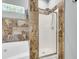 Bathroom showcasing a bathtub with decorative tile next to a shower with a glass door at 8166 Scottswood Dr, North Charleston, SC 29418