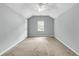 Neutral bedroom with a ceiling fan and window providing natural light, complemented by soft, neutral carpet at 8166 Scottswood Dr, North Charleston, SC 29418