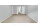 Spacious bedroom featuring plush carpeting, neutral walls, and multiple doors for easy access at 8166 Scottswood Dr, North Charleston, SC 29418