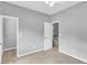Bedroom featuring neutral walls and carpet with access to a closet and hallway at 8166 Scottswood Dr, North Charleston, SC 29418