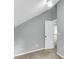 Cozy bedroom featuring neutral gray walls, plush carpeting, and a doorway leading to an adjacent space at 8166 Scottswood Dr, North Charleston, SC 29418