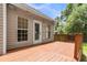Exterior shot showcasing the deck with a door leading into the home and lush greenery around at 8166 Scottswood Dr, North Charleston, SC 29418