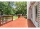 Exterior shot showcasing a wooden deck with railings, green grass, and access to a lush backyard at 8166 Scottswood Dr, North Charleston, SC 29418