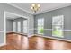 Open dining room area with natural light streaming through the windows, and hardwood flooring at 8166 Scottswood Dr, North Charleston, SC 29418