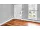 Neutral colored entryway with a storm door and hardwood flooring at 8166 Scottswood Dr, North Charleston, SC 29418