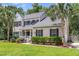 Charming two-story home with a welcoming porch and well-maintained landscaping at 8166 Scottswood Dr, North Charleston, SC 29418