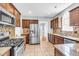 Spacious kitchen featuring stainless steel appliances, tile backsplash, granite counters, and tile flooring at 8166 Scottswood Dr, North Charleston, SC 29418