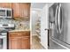 Well-organized kitchen featuring wooden cabinets, stainless appliances, granite counters, tile backsplash, and a pantry at 8166 Scottswood Dr, North Charleston, SC 29418