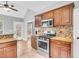 Well-equipped kitchen featuring wooden cabinets, stainless steel appliances, granite counters, and an open layout at 8166 Scottswood Dr, North Charleston, SC 29418