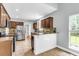 Bright kitchen with stainless appliances, granite counters, wooden cabinets, tile backsplash, and eat in breakfast bar at 8166 Scottswood Dr, North Charleston, SC 29418