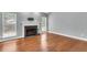 Bright living room featuring hardwood floors, fireplace, and large windows overlooking the yard at 8166 Scottswood Dr, North Charleston, SC 29418