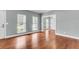 Bright living room with wood floors, natural light streaming through the windows, and an open doorway at 8166 Scottswood Dr, North Charleston, SC 29418