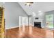 Spacious living room with vaulted ceiling, fireplace, hardwood floors, and open floor plan at 8166 Scottswood Dr, North Charleston, SC 29418