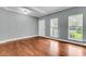 Inviting living room with wood floors, ample natural light streaming through the windows, and stylish crown molding at 8166 Scottswood Dr, North Charleston, SC 29418