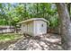 Backyard shed featuring beige siding, white trim, double doors, and a window for natural light at 8166 Scottswood Dr, North Charleston, SC 29418