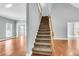 Bright foyer with a carpeted staircase leading to the upper level, complemented by hardwood floors at 8166 Scottswood Dr, North Charleston, SC 29418