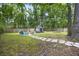 Beautiful backyard featuring a stone path, fire pit, storage shed, level lawn, and mature trees at 825 Savage Rd, Charleston, SC 29414