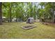 Large backyard with a fire pit, shed, level lawn, garden and mature trees at 825 Savage Rd, Charleston, SC 29414