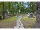 Spacious backyard featuring a fire pit, lush lawn, seating, a storage shed, and mature trees at 825 Savage Rd, Charleston, SC 29414