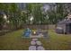 Inviting backyard with a fire pit, comfortable seating, storage shed and lush green grass at 825 Savage Rd, Charleston, SC 29414