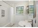 Bright bathroom featuring tiled walls, a tub with shower, and modern sink with stylish faucet at 825 Savage Rd, Charleston, SC 29414